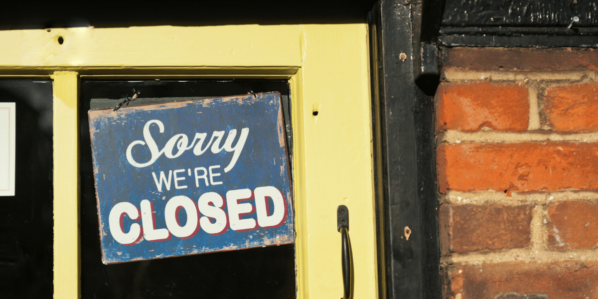 A shop door with a closed sign
