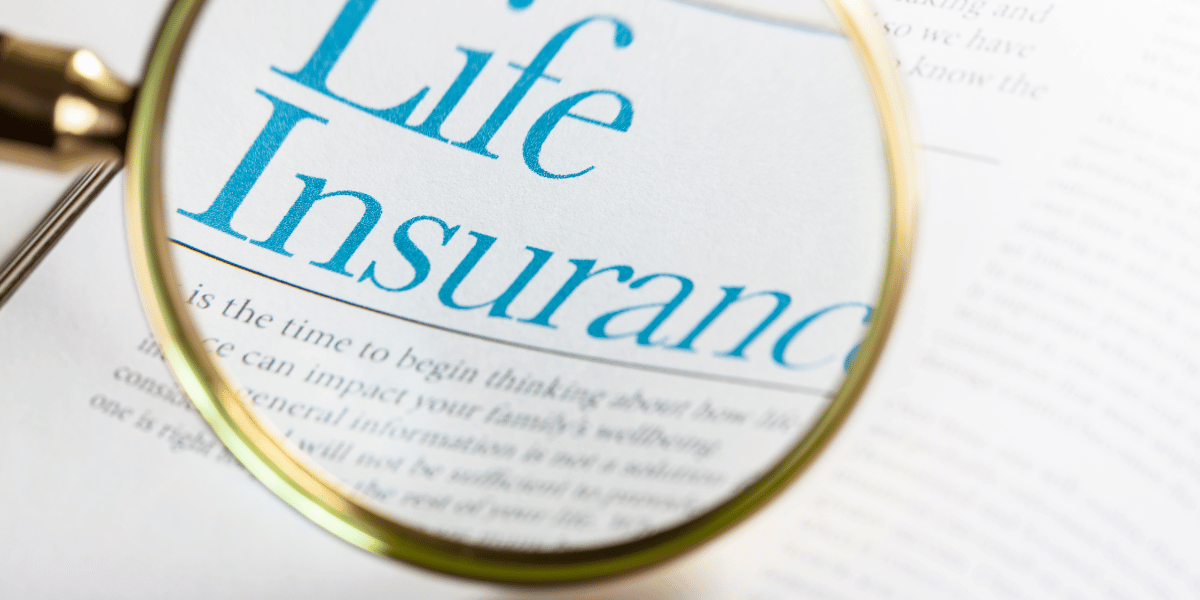 A life insurance policy being examined using a magnifying glass